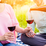 couple-lovers-drinking-red-wine-picnic-1 1